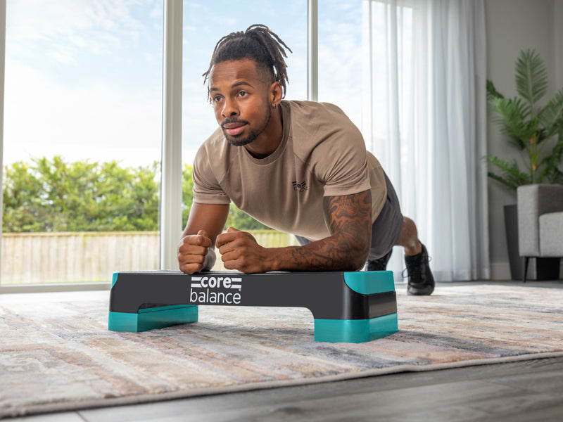 Man performing a plank on a Core Balance aerobic step.